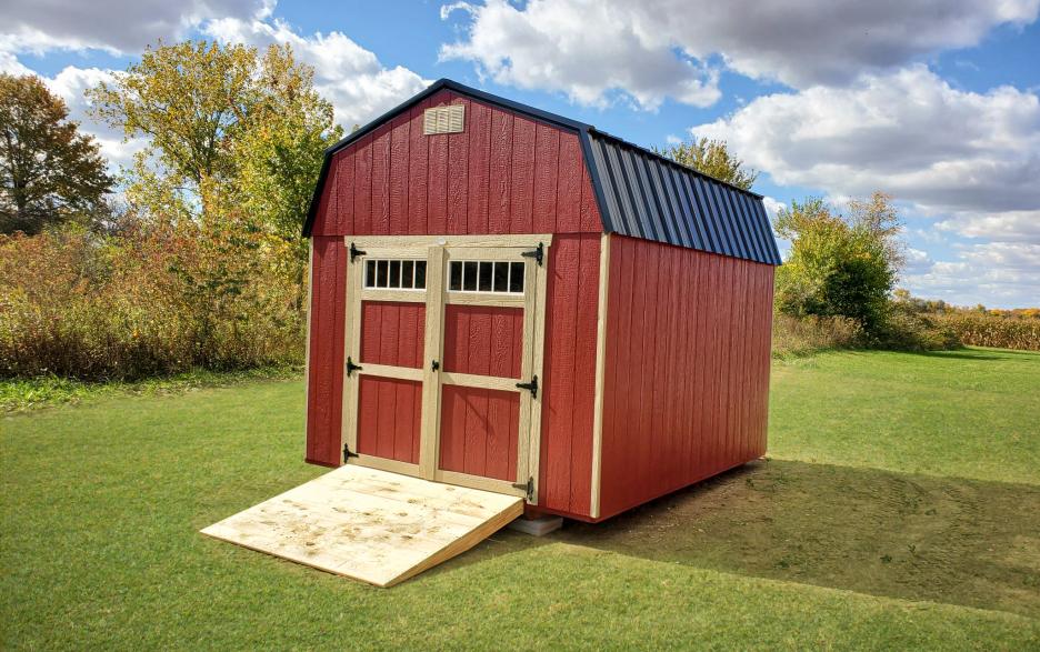 Compass High Barn: mountain red siding with double doors, khaki trim and black roofing
