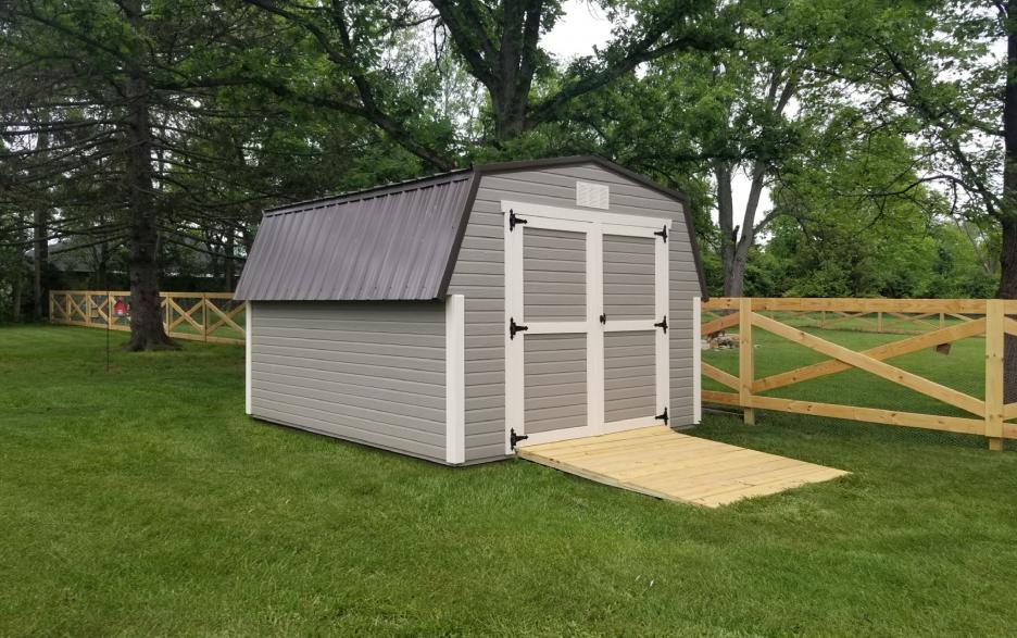 Signature Mini Barn: clay dutchlap siding with double doors, Navajo white trim and burnished slate roofing.